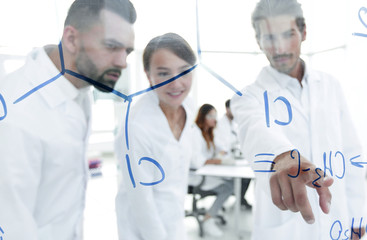 group of laboratory scientists discussing their research in the laboratory.