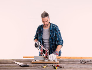 worker in blue  shirt sawing wood