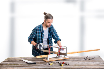 worker in blue  shirt sawing wood