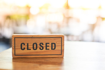 The wooden sign says closed