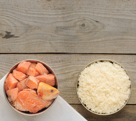 Natural ingredients for dog food in four bowls on old wooden background