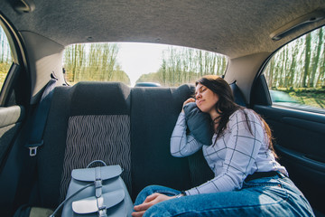woman at car backseats sleeping. car travel concept