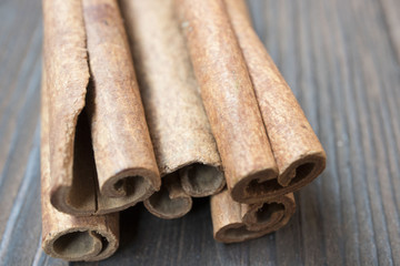 Cinnamon sticks and meal close up on wooden table