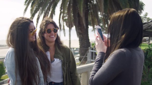 Young Woman Takes Vacation Photos Of Her Friends Posing, Palm Trees And Beach In Background - Shot On Red Scarlet-W Dragon In 4K, Slow Motion