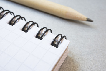 Fototapeta premium Notepad and simple pencil, macro photo, business concept, work. close up