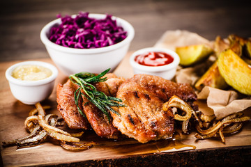 Grilled steak with baked potatoes and vegetables