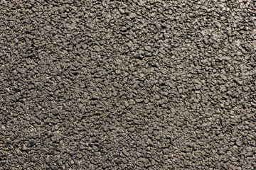 The texture of the roadway is asphalt.  Close-up