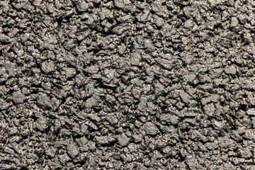 The texture of the roadway is asphalt.  Close-up