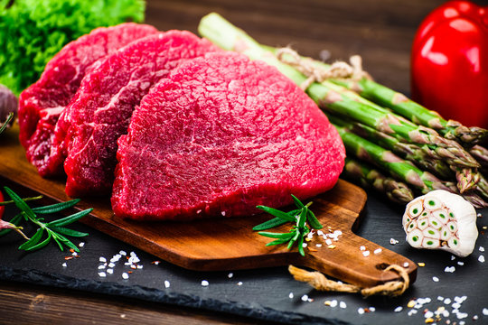 Fresh raw beef steaks on white background