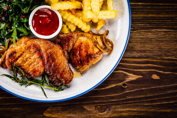 Grilled beefsteak with french fries and vegetable salad