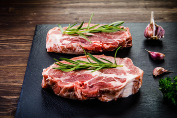Raw pork on black stone