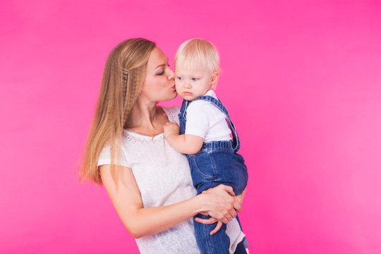 mother and daughter having fun isolated on pink background