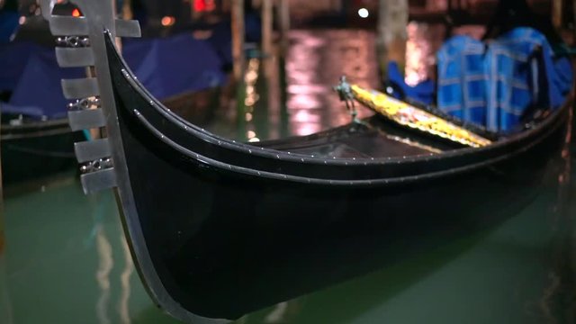 Row of gondolas and glowing streets. Italy, Europe