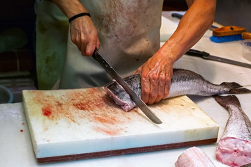 Man cutting fish on fish market