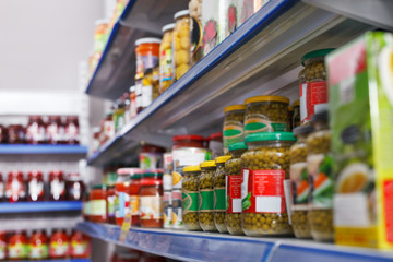 Fototapeta premium Different pickle goods at shelves in food store