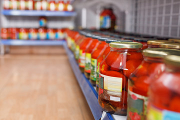 Different pickle goods at shelves in food store