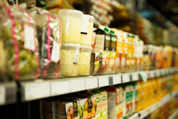 Shelves with variety grocery products in the supermarket