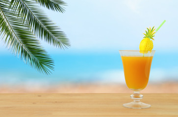 image of tropical and exotic fruit coctail over wooden table infront of sea landscape background.