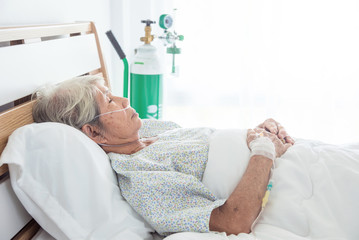 Asian senior female patient sleeping on bed in hospital