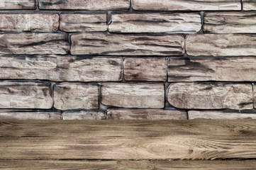 The background is a wall of brown bricks and wooden boards.