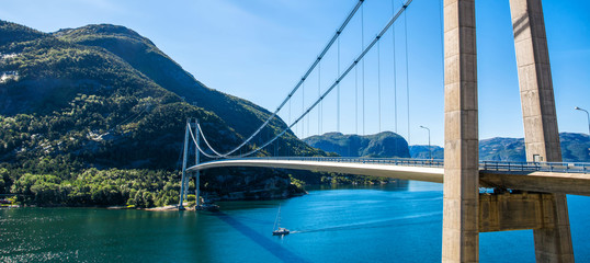 Typical Norwegian view of the bridge across the fjord. Colorful summer day in the Norway. Travel concept. Artistic picture. Beauty world - obrazy, fototapety, plakaty