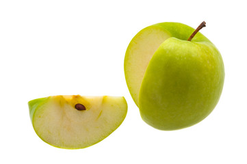 Slice is cut from a large fresh green apple on a white background.