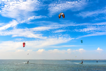 Kiteboarding. A kite surfers rides the waves. Recreational activities, water sports, hobbies and fun in summer. Artistic picture. Beauty world.