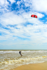 Kiteboarding. A kite surfer rides the waves. Holidays on nature. Artistic picture. Beauty world. © olenatur