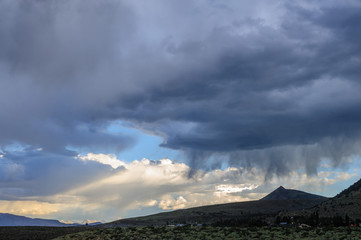 Threatening storm clouds are hanging low over mono lake, near the town of Lee Vining, in the Sierra...