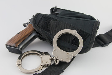 Handgun in tactical SWAT holster with handcuffs