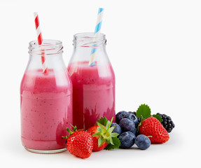 Fresh liquidised berry smoothies in bottles