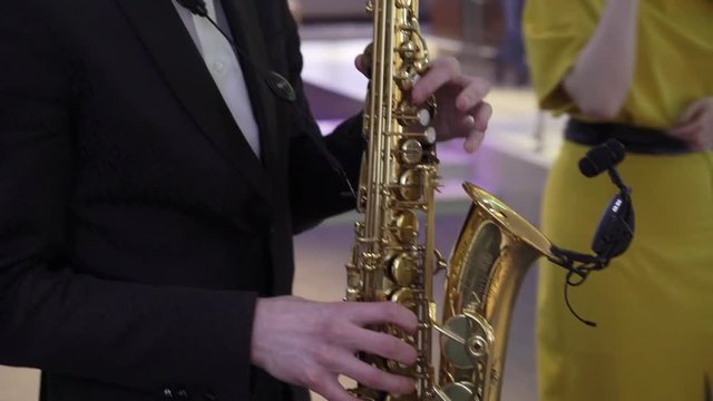 Man playing music on golden saxophone