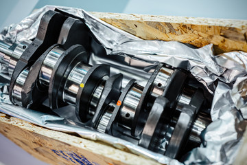The crankshaft is packed in aluminum foil and lies in a wooden box.