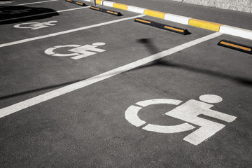 handicap parking in a row, wheelchair parking symbole on asphalt road
