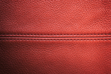 Closeup red leather with sewing seam for background