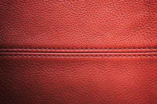 Closeup red leather with sewing seam for background