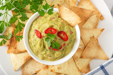 Guacamole sauce with tortilla chips.