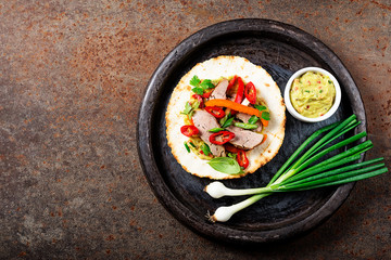 Mexican tacos with roasted  duck  meat, vegetables and green onion. Top view