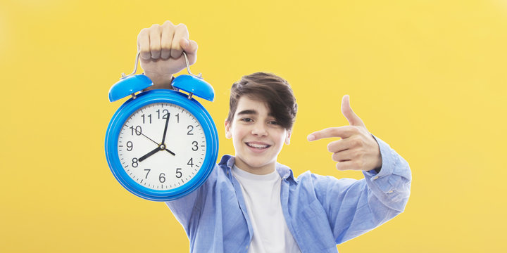 young person with clock or alarm, concept of time and punctuality