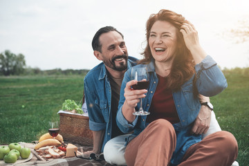 Wonderful day for being together. Portrait of excited loving couple having romantic picnic on the...