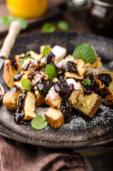 Cutted pancakes, Kaiserschmarrn delish dessert with plums