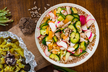 Fresh summer salad with radish, tomatoes, cucumbers. Raw vegan vegetarian food
