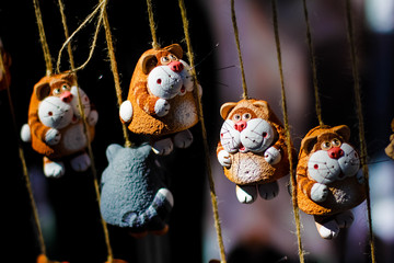 Ceramic cats on ropes
