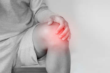 Knee joint pain, a man suffering from knee pain , on white background