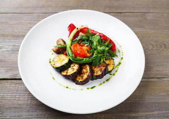Grilled vegetables with herbs, pesto sauce and balsamic vinegar. Vegetarian meals, Mediterranean cuisine, food photo, restaurant menu, home cooking 