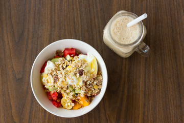 Healthy breakfast with fruit, muesli, yogurt and coffee shake. From top