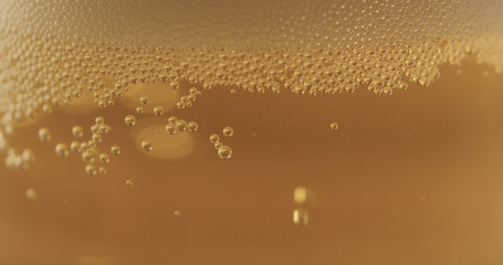 closeup of lager beer pouring in a glass