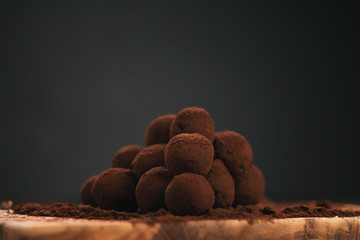 craft chocolate truffles on wooden board with cocoa powder
