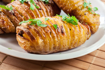 Baked potatoes with cheese and herbs