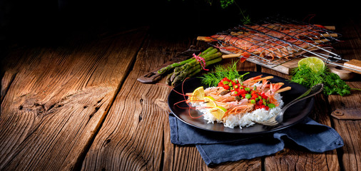 grilled red argentine shrimps with red salsa and green asparagus